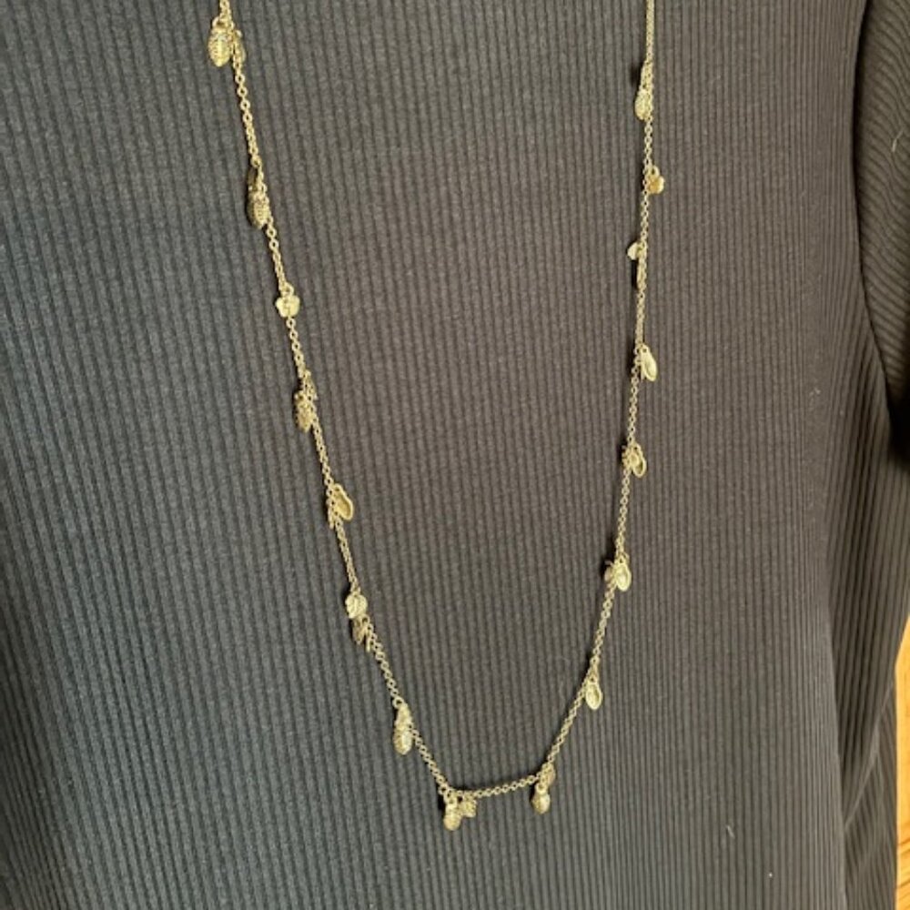 Long necklace pewter type color with clusters of leaf, pine cone & flower charms